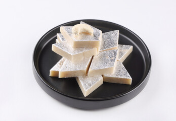 Indian Sweet called Kajukatli or Kajuukatli serve in plate isolated on white background 