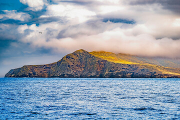 Striking dramatic skies hang over the coastal shores of the Channel Islands during a colorful...