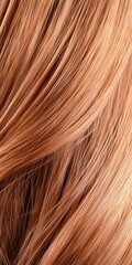 Fototapeta premium Close-up of long light brown wavy hair illuminated by soft dreamy light, showcasing the texture and frizz on the left side