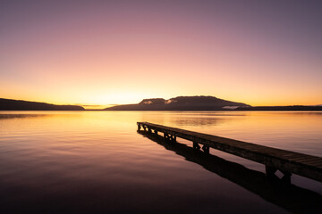 New Zealand landscape of a lake and jetty at sunrise