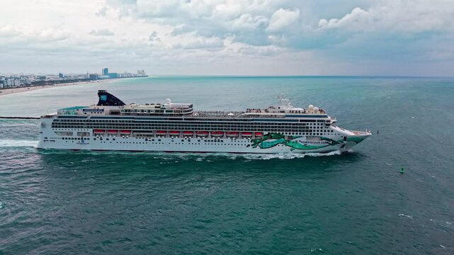 Miami, Florida, USA - March 12, 2025: Ship leaving Miami beach port. Norwegian Jade cruise ship voyage. Cruise in summer vacation. Norwegian cruise line. Cruise ship tour travel at sea. Travel memory