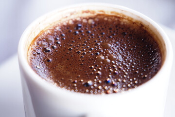 Rich turkish coffee in a white cup