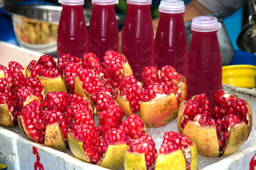 Pomegranates and bottles of pomegrante juice