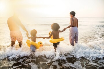 Black family having fun on the beach