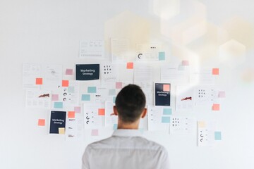 Business man planning on a wall