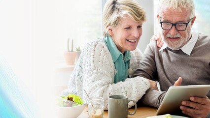 Senior couple using a tablet remix