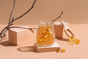 Composition with jar of fish oil capsules, plaster decor and tree branch on color background