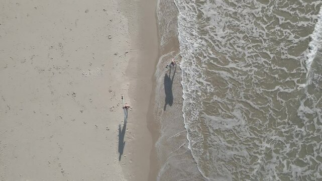Aerial View of Surfers Emerging from the Waves at Byron Bay