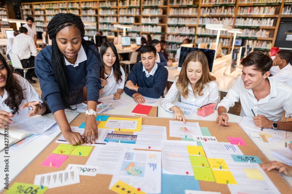 Aufkleber Diverse group of students collaborating in a library, discussing projects, sharing ideas, and working together around a table filled with colorful papers and notes. Young diverse students learning.