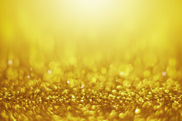 gold sparkle texture abstract background with soft bokeh twinkled light for Christmas and backdrop wallpaper design.