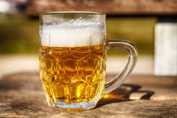Glass of beer on a bench close up