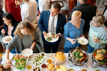 Fotobehang Diverse group enjoying buffet. Diverse people chatting and eat buffet. Social gathering with a variety of cuisines and appetizer. Business colleagues eat buffet. Catering at business company event © Rawpixel.com
