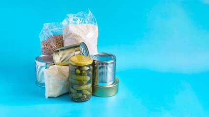 A set of products that can be stored for a long time. Banner with various products, cereals, pasta, canned food in close-up on a light background