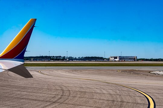 Orlando, FL, USA - March 18, 2025
- The runway and buildings of Orlando International Airport (MCO) during the middle of the day