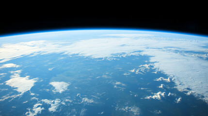 breathtaking view of Earth from space shows planet curvature, with clear blue atmosphere and scattered clouds over surface, evoking sense of wonder and tranquility