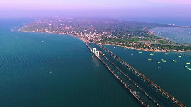 aerial drone view of a coastal road pamban bridge , tamilnadu