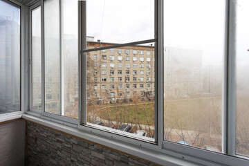the balcony of an apartment on the upper floors of an apartment building