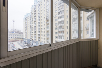 the balcony of an apartment on the upper floors of an apartment building