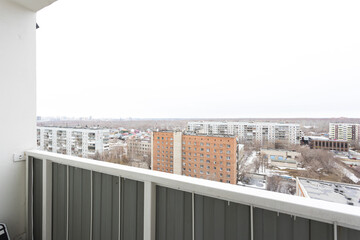 the balcony of an apartment on the upper floors of an apartment building