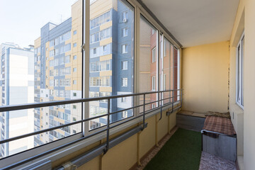 the balcony of an apartment on the upper floors of an apartment building