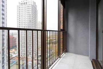 the balcony of an apartment on the upper floors of an apartment building