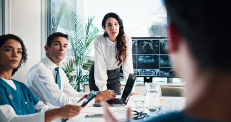 Woman, doctor or team collaboration with x ray on screen for meeting or planning surgery in boardroom. Female person, speaker or medical group with CT scan or display for health diagnosis or results