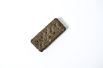 Photo of black biscuit with peanut cream and sugar on the topping isolated on white background. Top view.