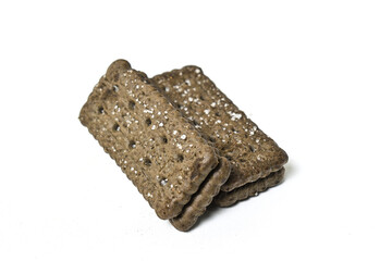 Photo of 2 or two black biscuit with peanut cream and sugar on the topping isolated on white background. Stack.