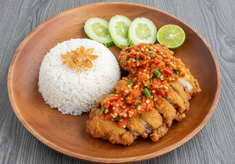 Spicy Chili Garlic Fried Chicken with Rice and Cucumber Slices on Wooden Plate