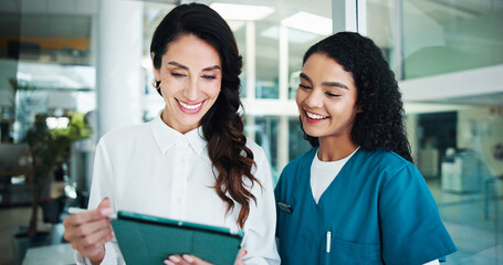 Doctors, smile and women in hospital, tablet and talking with online reading for diagnosis....