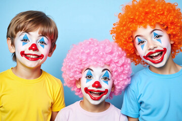 three children dressed up as clowns on a blue background