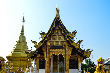 Fototapeta premium Pagoda and Chapel, Lanna Architecture, Symbols of Buddhism, South East Asia at San Pu Loei Saleewiangkaew Temple, Chiang Mai, Northern Thailand