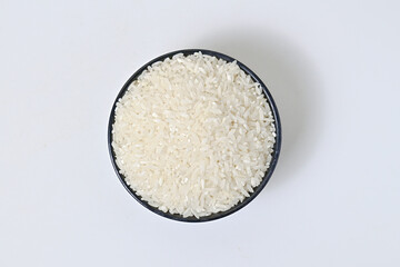 Top view of rice in black bowl, isolated on white background, clipping path, full depth of field, ingredients, calories.