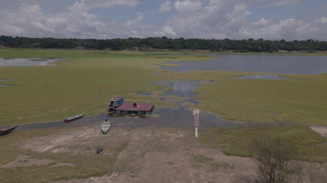 Rio Negro Amazon River - Capim grass and boats - push in aerial drone shot