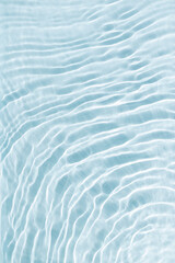 Clear water and waves at sunlight, sun flare and bright white reflections on blue, turquoise water...