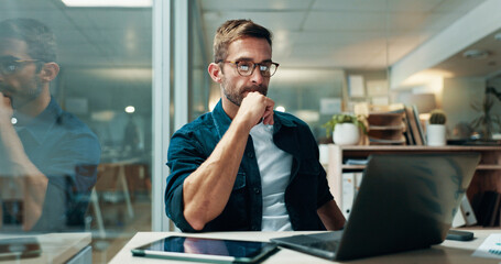 Businessman, reading and office with laptop, report and confidence for bookkeeping as accountant. Male person, night and strategy in finance agency, banking or investment opportunity for payroll job