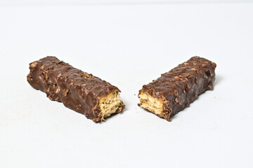 Photo of stack chocolate bar filled with wafer isolated on white background. Wafer chocolate caramel. Broken in half. Close up view.