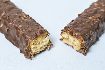 Photo of stack chocolate bar filled with wafer isolated on white background. Wafer chocolate caramel. Broken in half. Close up.