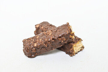 Photo of stack chocolate bar filled with wafer isolated on white background. Wafer chocolate caramel. Broken in half. Close up.