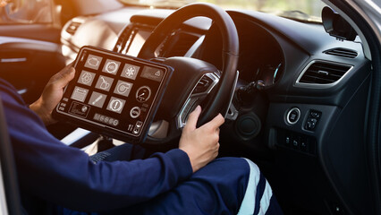 Auto mechanics use tablet computers with cutting-edge interactive diagnostic software to find...