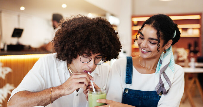Couple, cafe and share drink on date for taste test, green juice and happy with bonding. Gen z people, smile and relationship in restaurant with relax, smoothie flavor and weekend break with support - Powered by Adobe