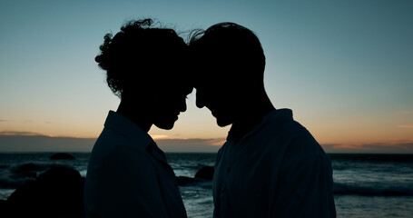 Forehead touch, beach and couple at sunset for bonding, relationship and relax on weekend. Dating,...