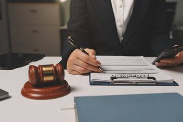 Judge gavel with Justice lawyers having team meeting at law firm background. Concepts of Law and...