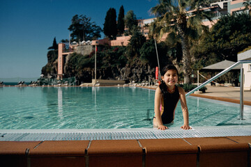 girl in outdoor swimming pool at hotel