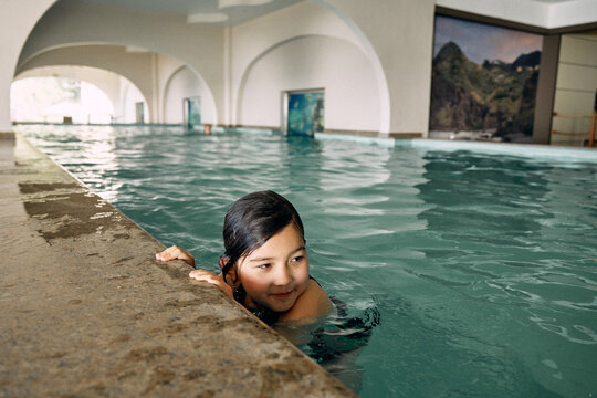 father and daughter in indoor swimming pool