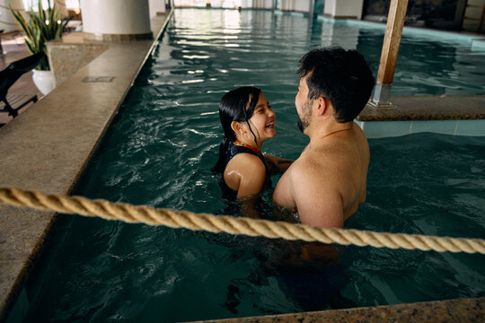 father and daughter in indoor swimming pool