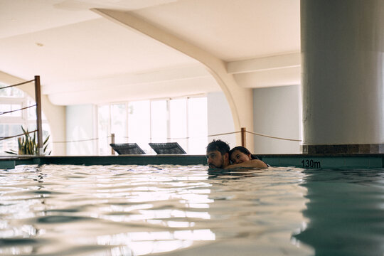 father and daughter in indoor swimming pool