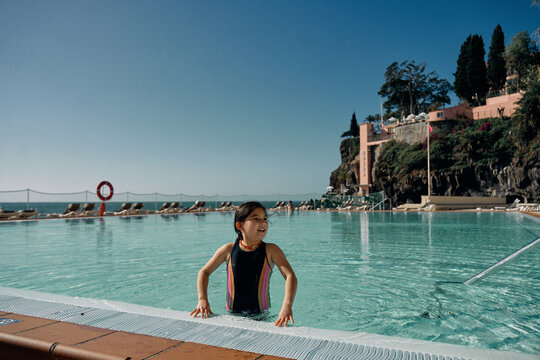 girl in outdoor swimming pool at hotel