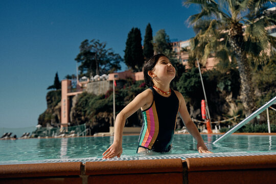 girl in outdoor swimming pool at hotel