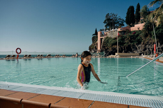 girl in outdoor swimming pool at hotel
